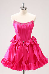 Hermoso vestido de fiesta fucsia de corte A, sin tirantes, con corsé, volantes, cuentas y lazos
