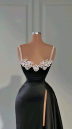 Elegant black evening gown with beaded straps and high slit, displayed on mannequin at ZAPDRESS.