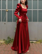 Woman in elegant red satin gown with puff sleeves and pearl necklace, ZAPDRESS fashion