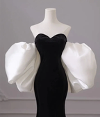 Elegant black evening dress with dramatic white puff sleeves on mannequin, ZAPDRESS fashion