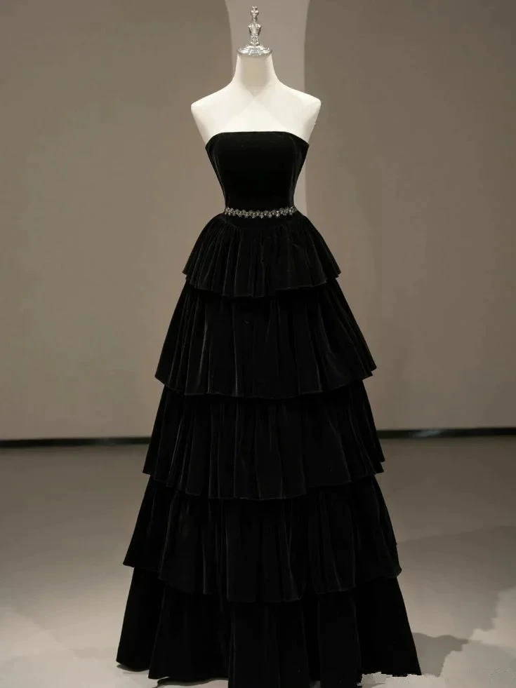 Elegant black strapless tiered velvet evening gown on mannequin at ZAPDRESS