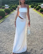Woman in elegant white cutout maxi dress outdoors, ZAPDRESS fashion, garden setting