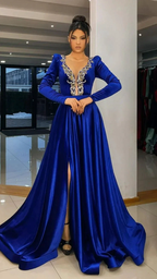 Woman in royal blue evening gown with gold embroidery and front slit at ZAPDRESS store