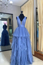 Elegant layered blue tulle evening gown on mannequin in boutique, ZAPDRESS fashion store