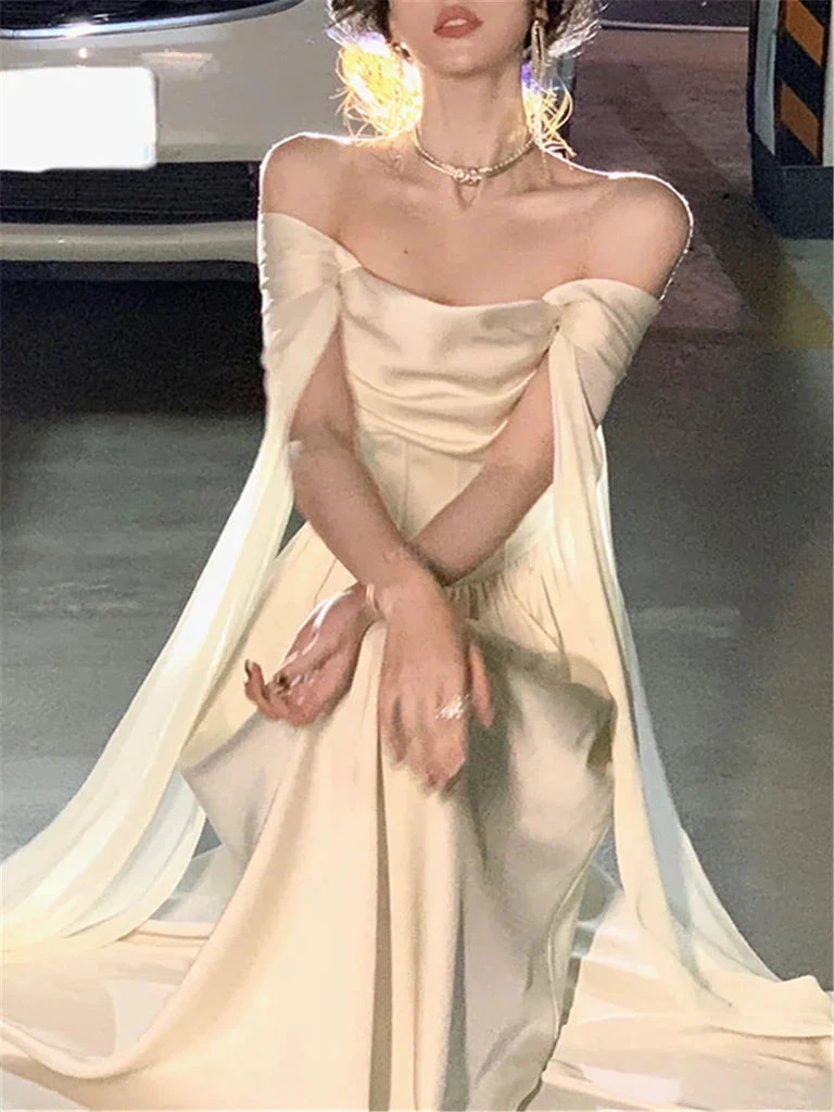 Elegant off-shoulder cream evening gown from ZAPDRESS, photographed in a parking garage