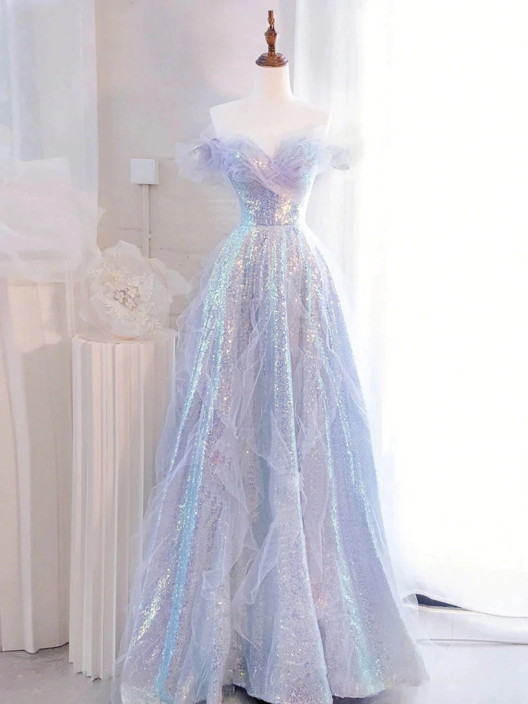 Iridescent off-shoulder sequin evening gown on mannequin in bright room, ZAPDRESS