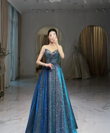 Woman wearing a sparkly blue ball gown in a boutique, ZAPDRESS evening dress fashion