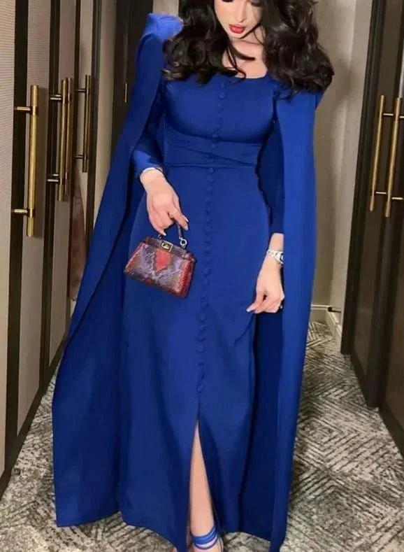 Woman in a royal blue cape dress with buttons, holding a small handbag, ZAPDRESS fashion