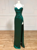 Emerald green evening gown with corset bodice and high slit on mannequin at ZAPDRESS