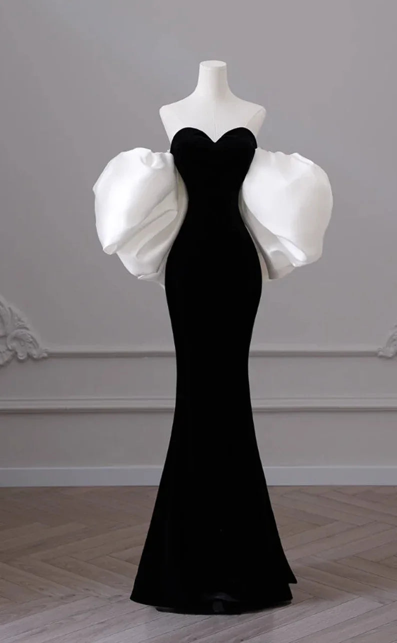 Elegant black evening gown with dramatic white puff sleeves on mannequin, ZAPDRESS fashion