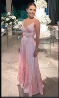 Woman in a light pink tiered dress at an elegant event with floral decor and cake, ZAPDRESS