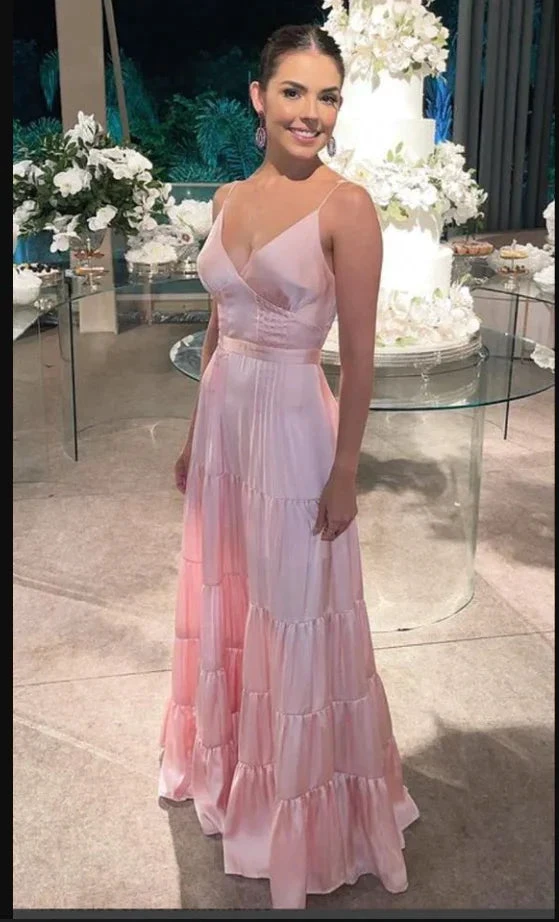 Woman in elegant pink satin dress at event with floral decor, ZAPDRESS formal gown