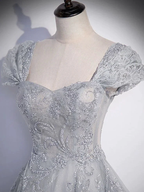 Elegant silver sequin embroidered dress on mannequin from ZAPDRESS