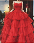 Woman wearing a layered red tulle ball gown dress outside a boutique, ZAPDRESS fashion