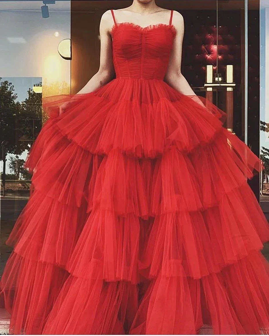 Woman wearing a layered red tulle ball gown dress outside a boutique, ZAPDRESS fashion