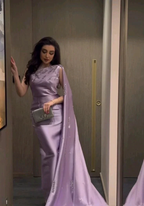 Woman in elegant lavender evening gown with silver clutch by ZAPDRESS, standing indoors