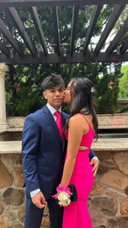 Couple in formal wear, woman in bright pink dress, outdoor setting with pergola, ZAPDRESS style