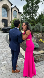Young couple in formal attire, woman in bright pink dress, outside elegant house, ZAPDRESS style