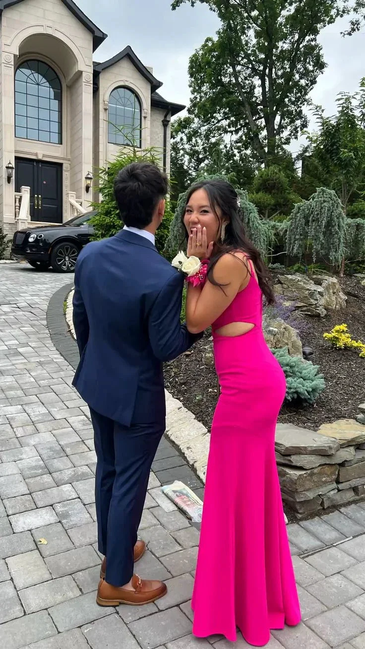Young couple in formal attire, woman in bright pink dress, outside elegant house, ZAPDRESS style