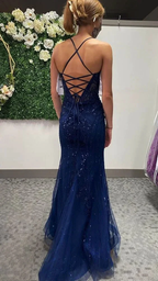 Woman in navy blue sequin evening dress with lace-up back, ZAPDRESS boutique setting