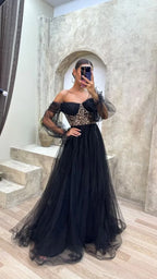 Woman wearing elegant black tulle evening gown with gold lace bodice, ZAPDRESS fashion