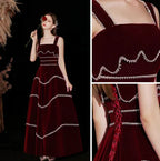 Woman wearing dark red velvet evening dress with silver trim from ZAPDRESS, elegant design details