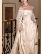 Elegant woman in off-shoulder white satin gown with long sleeves, ZAPDRESS fashion style