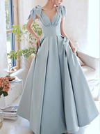 Elegant light blue evening gown with bows on shoulders, pleated skirt; ZAPDRESS fashion style