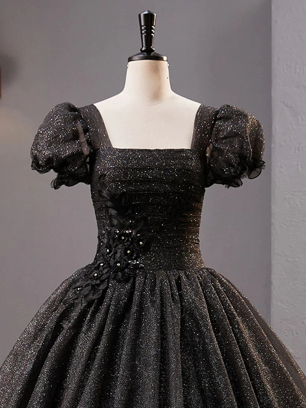 Elegant black glitter dress with puff sleeves and floral details on mannequin, ZAPDRESS