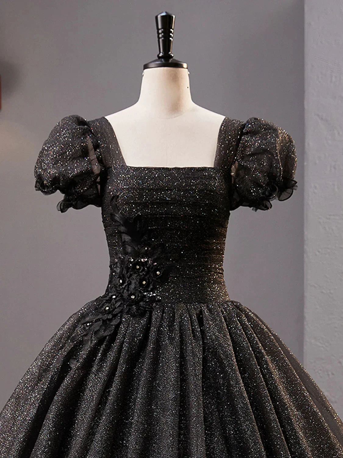 Elegant black glitter dress with puff sleeves and floral details on mannequin, ZAPDRESS