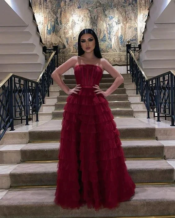 Woman in elegant red ruffle evening gown on staircase, formal dress ZAPDRESS fashion
