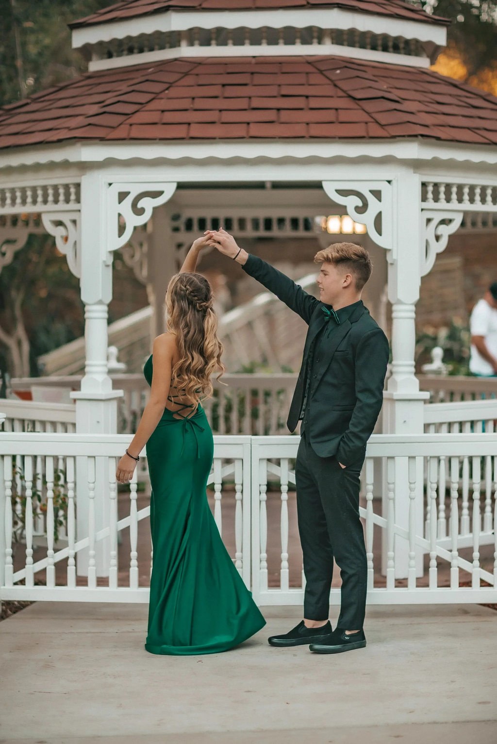Young couple dancing in formal attire at a gazebo, woman in green dress, ZAPDRESS