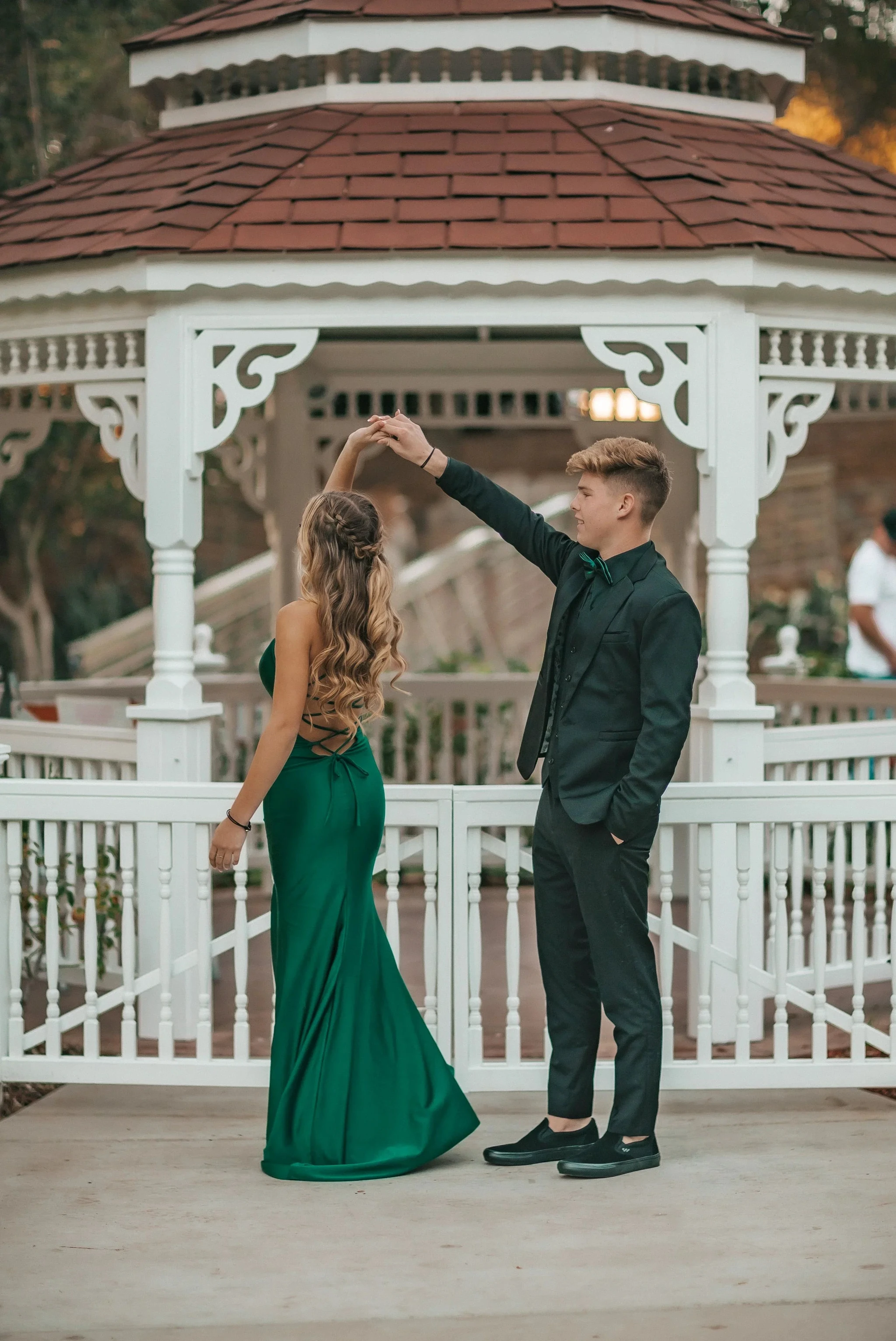 Young couple dancing in formal attire at a gazebo, woman in green dress, ZAPDRESS