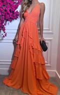 Woman in an elegant orange ruffled evening gown holding a black clutch, ZAPDRESS fashion