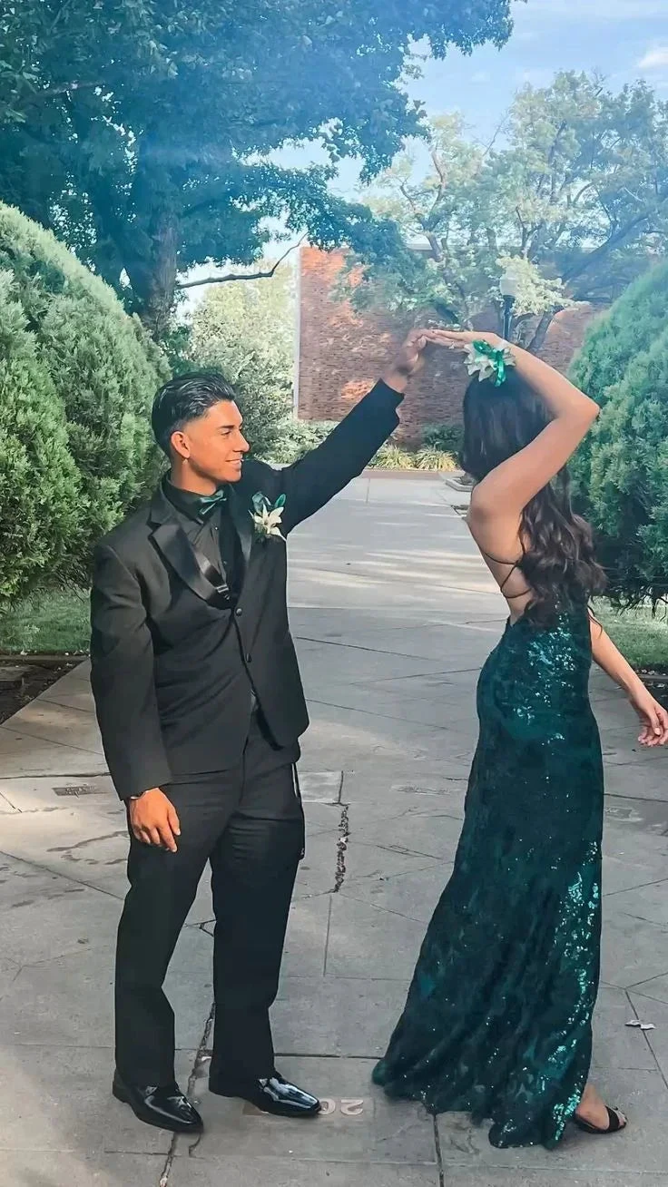 Couple dancing outdoors, man in black suit and woman in green sequin dress, ZAPDRESS event style