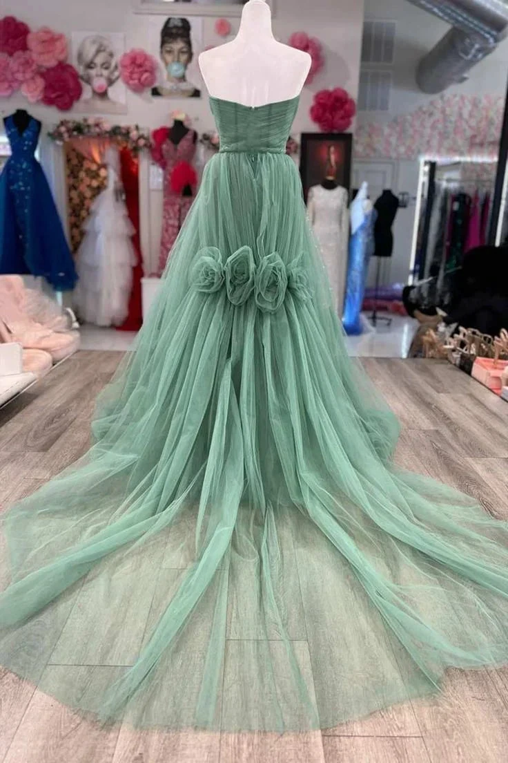 Elegant mint green tulle evening gown with floral waist details on display at ZAPDRESS boutique