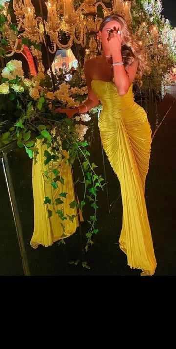 Woman in yellow ruched evening gown at floral chandelier event, ZAPDRESS fashion style
