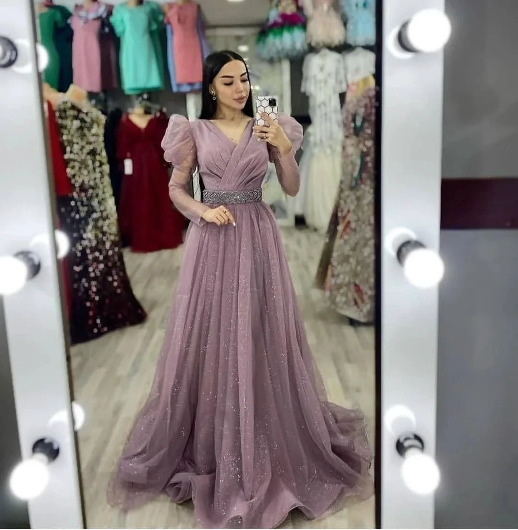 Woman in sparkly mauve evening gown taking mirror selfie in ZAPDRESS boutique