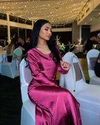 Woman in elegant magenta satin dress at formal event, ZAPDRESS evening fashion