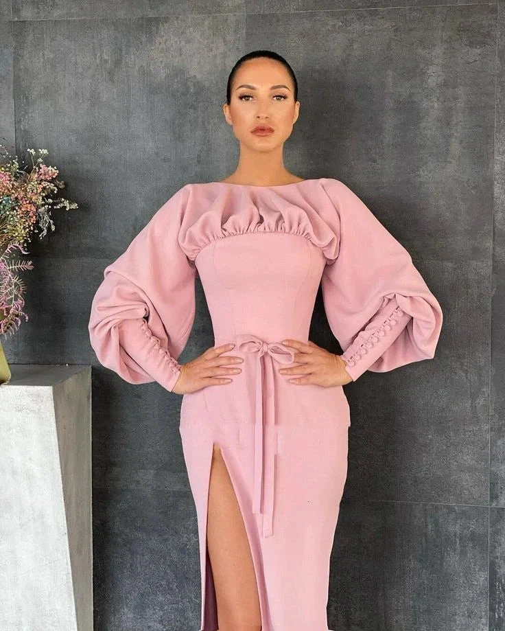 Woman in pink puff sleeve dress with front slit, posing against dark wall, ZAPDRESS fashion