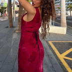 Woman in a red velvet dress outdoors, palm trees and city street, ZAPDRESS fashion