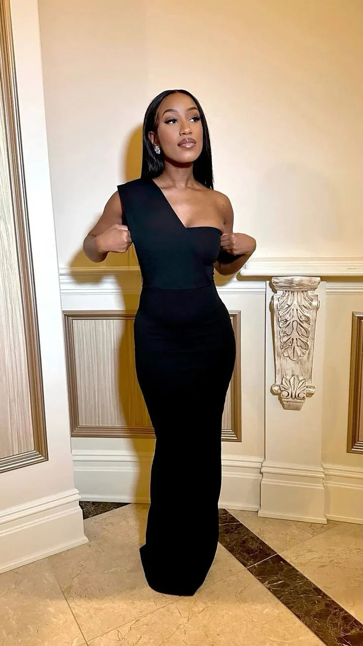 Woman in elegant black one-shoulder evening gown in ornate interior, ZAPDRESS fashion