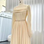 Elegant cream pleated long dress with floral waist detail on mannequin at ZAPDRESS store