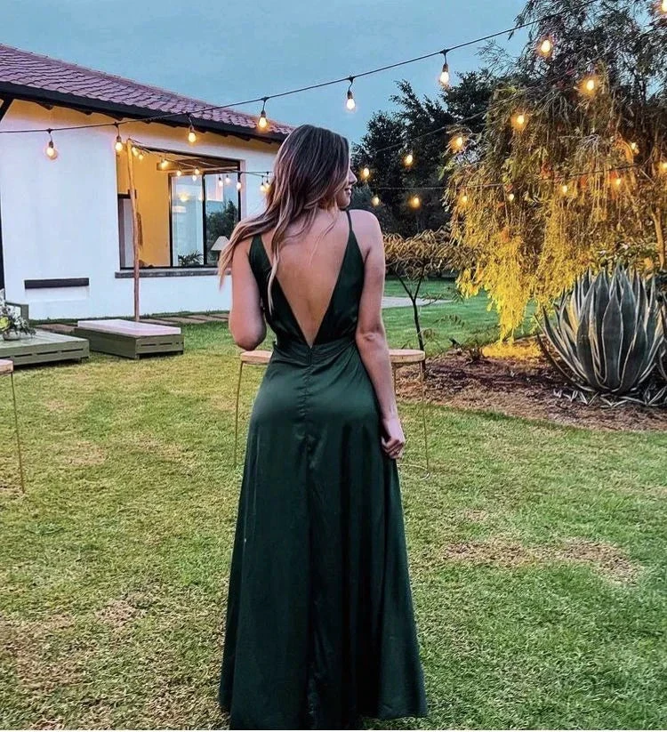 Woman in elegant green backless dress standing outdoors at dusk under string lights, ZAPDRESS