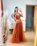 Woman in a long orange evening dress takes a mirror selfie in a modern bedroom, ZAPDRESS fashion
