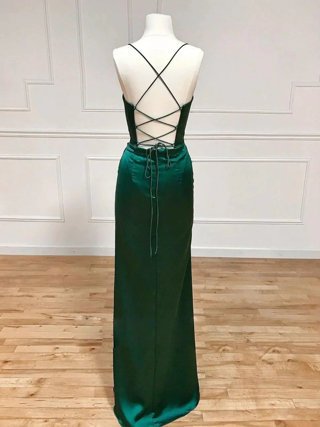 Emerald green satin evening dress with open lace-up back on mannequin, ZAPDRESS fashion