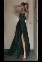 Woman modeling a dark green satin evening dress with spaghetti straps and high slit, ZAPDRESS