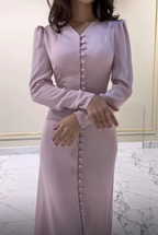 Elegant light pink long sleeve dress with button details from ZAPDRESS, marble floor background