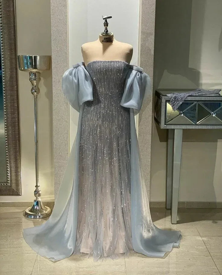 ZAPDRESS silver glitter evening gown with puffy sheer sleeves on mannequin in showroom