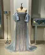 ZAPDRESS silver glitter evening gown with puffy sheer sleeves on mannequin in showroom